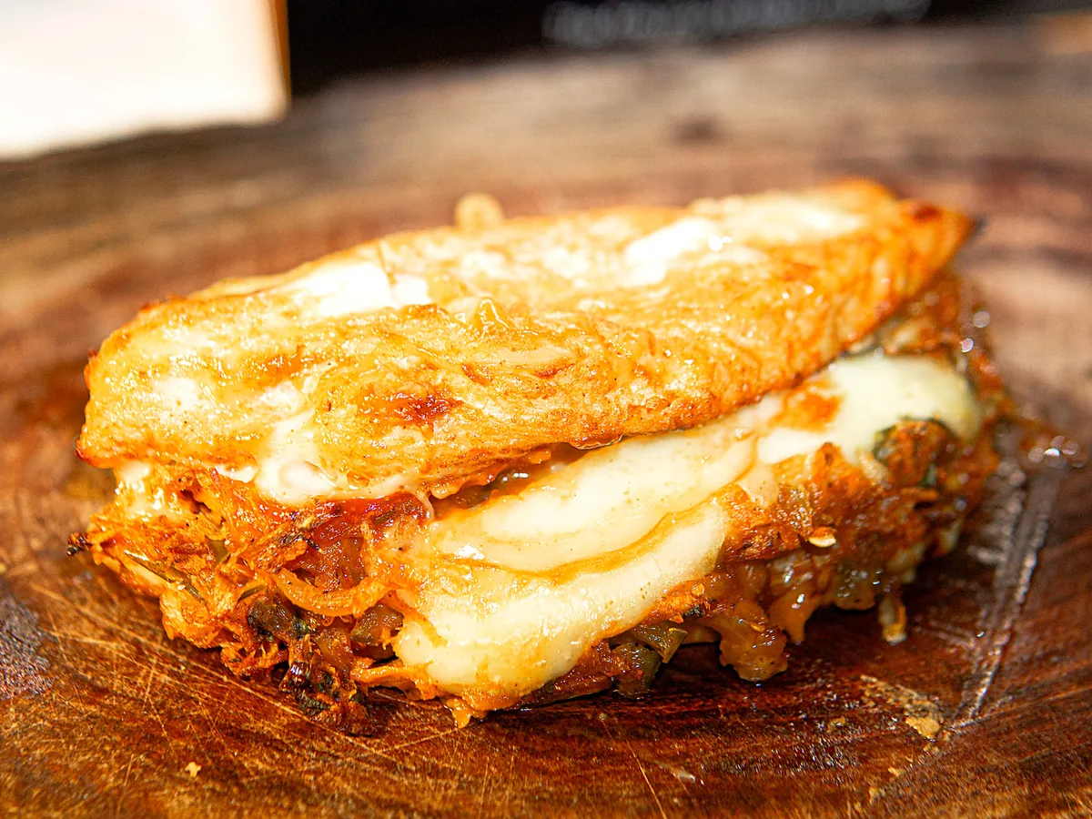 Fuego Loaded Chicken Melt, cut open with cheese pulling